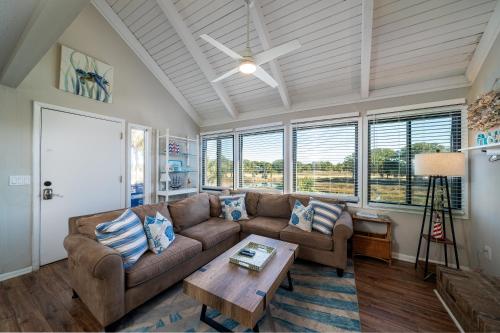 a living room with a couch and a table at 815 Treeloft Cottage in Seabrook Island