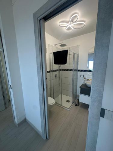 a bathroom with a toilet and a tv in it at Villa Asia Relais in Massa Lubrense