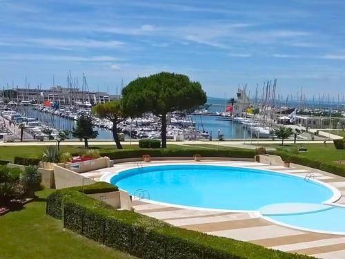 - une piscine avec vue sur le port de plaisance dans l'établissement Port Horizon - T3 terrasse vue port climatisé piscine WIFI résidence Escale Port, au Grau-du-Roi