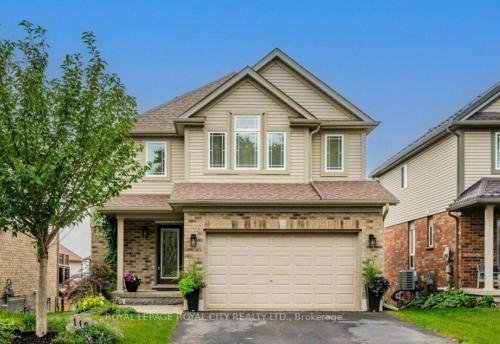 a large house with a garage at Modern,1BR Guesthouse Studio in Guelph