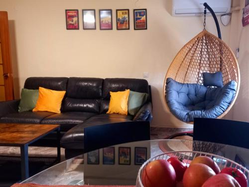 a living room with a couch and a hanging chair at Cozy Flat with City & Beach in Puerto de Sagunto