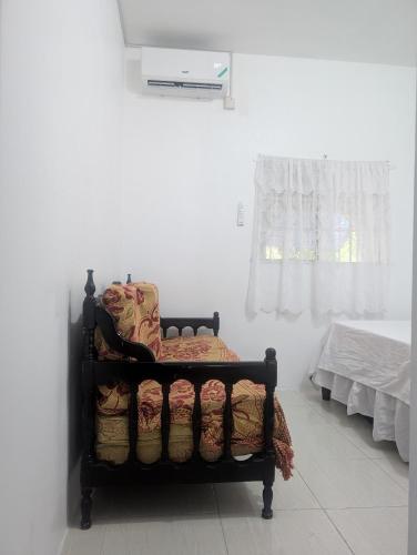 a bed sitting in a room next to a window at TwentyFive at Tower Isle in Tower Isle