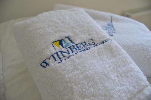 a white towel with the word mattress on it at Wijnberg Appartementen in Hollum