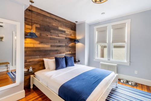 a bedroom with a large bed with a wooden headboard at Paws on Pelham in Newport