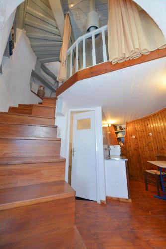 a staircase in a house with a white door and a stair case at Windmill Villas in Artemonas