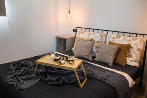 a bedroom with a bed with a coffee table on it at MFapartments in Vrbovec