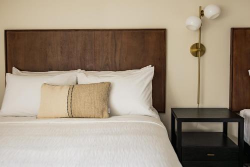 a bedroom with a large bed with a wooden headboard at The Vic by Kasa in Traverse City