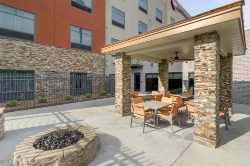 a patio with a table and chairs and a fire pit at Best Western Plus Elizabethtown Inn & Suites in Elizabethtown