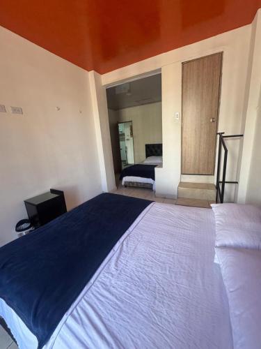 a bedroom with a large bed in a room at Hotel Cañaveral Plaza 2 in Manizales