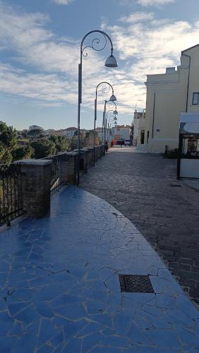 a cobblestone street with street lights next to a building at Pantarey in Ortona