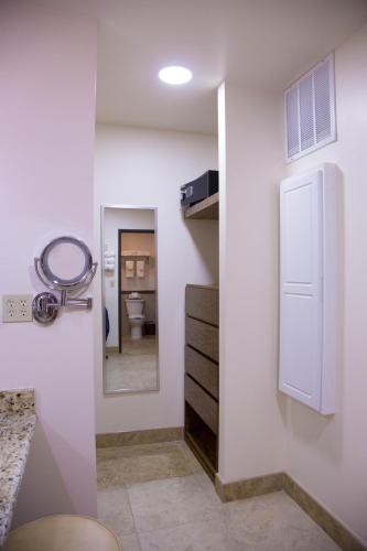 a bathroom with a mirror and a sink and a mirror at La Villa de Zaragoza in Tijuana
