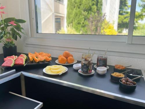 a buffet with different types of food on a table at The Originals Access, Hôtel Innostar in Labège