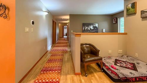 a hallway with a couch and a chair and a carpet at Evergreen Haven in Port Angeles