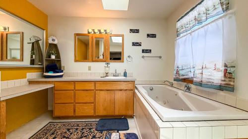 a bathroom with a tub and a sink at Evergreen Haven in Port Angeles