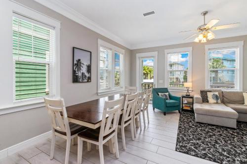 a dining room with a table and chairs and a couch at Two if by Sea in Mexico Beach