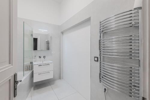 a white bathroom with a sink and a mirror at Heart of Prague Lodgings 3 in Prague