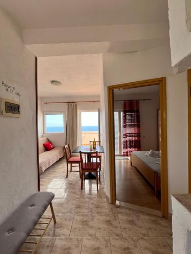a room with a table and a bed and a mirror at Apartmani "Nikola" Seaview - Ivan Dolac, Hvar in Ivan Dolac