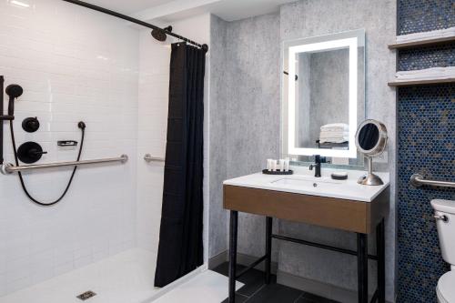 a bathroom with a sink and a shower at Hotel Indigo Chattanooga - Downtown by IHG in Chattanooga