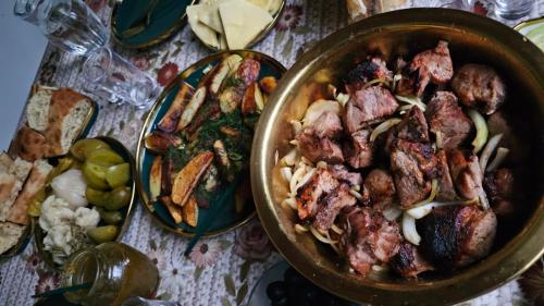 a table with a pan of food and a plate of food at Vardzia Old Village in Vardzia