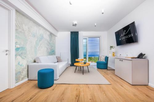 a living room with a white couch and a table at Hotel In Excelsis in Novalja