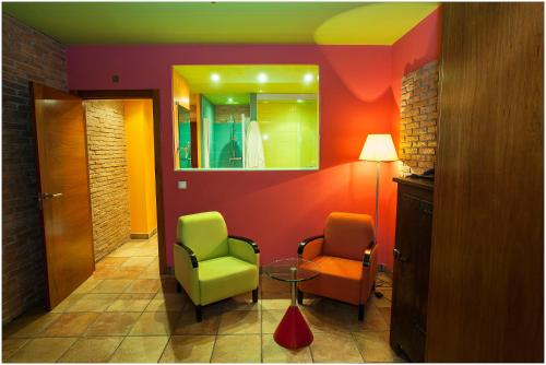 a room with two chairs and a table and a mirror at Hotel Ibaiondo in Olave