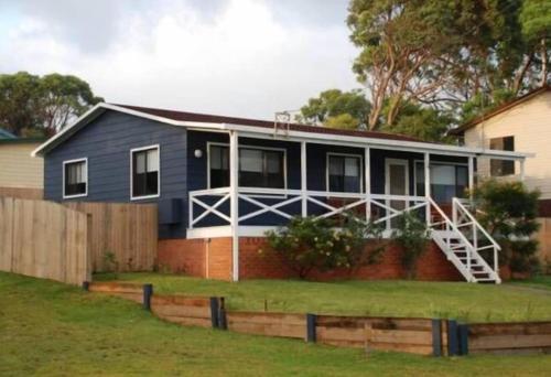 a house with a fence in front of it at BeachBreaksManyana in Manyana