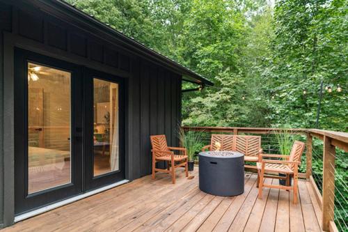 a deck with chairs and a table on a house at Modern Mountain Retreat in Gatlinburg