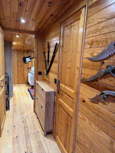 a room with a wooden wall with skis on it at Calm, Comfort and Simplicity in Sens