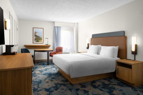 a hotel room with a bed and a desk at Hampton Inn Miami-Airport West in Miami