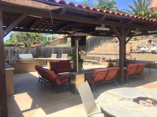 a patio with chairs and tables and a pavilion at Room in Bay Park, San Diego in San Diego