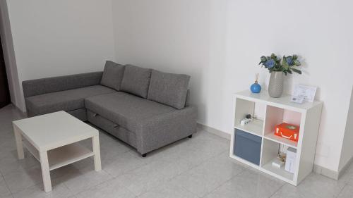 a living room with a couch and a table at Appartamento in residence "CASA DAMIA" in Taranto