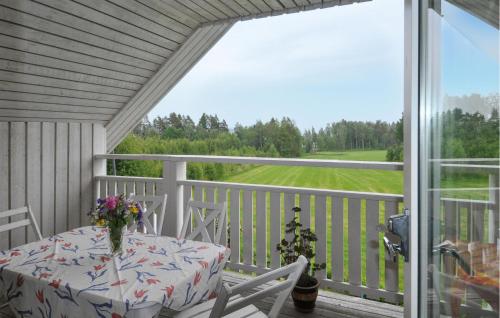 a table and chairs on a porch with a view at Villa Utsikten in Kristinehamn