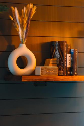 a shelf with a vase and books on it at The A-Frame at Finch Creek in Bellaire