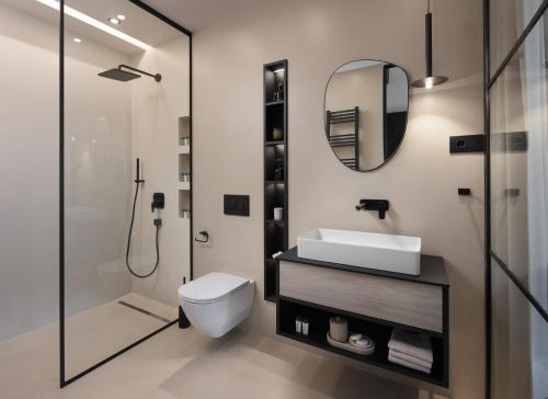 a bathroom with a toilet and a sink and a mirror at Casa Olivetta in Visočane