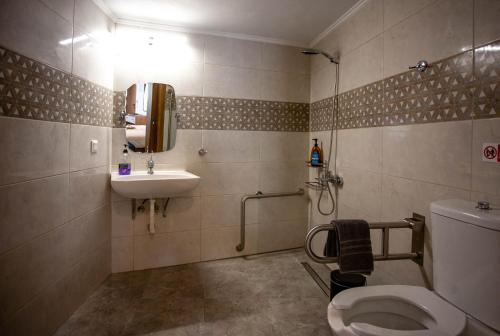 a bathroom with a toilet and a sink at AZOGIRE Resort in Azoyirés