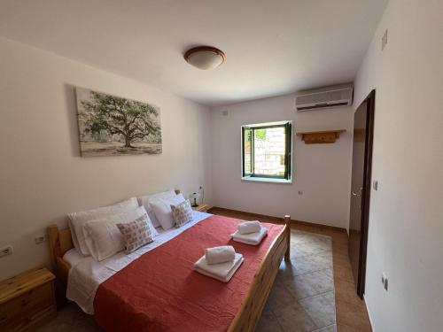 a bedroom with a bed with two towels on it at Villa Silentia in Lastovo