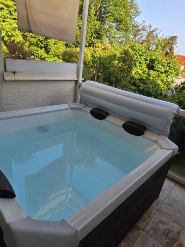 a hot tub sitting on top of a patio at Ferienwohnung Kempten (Allgäu) in Kempten