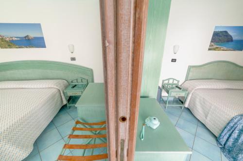 Кровать или кровати в номере Hotel Casa del Sole