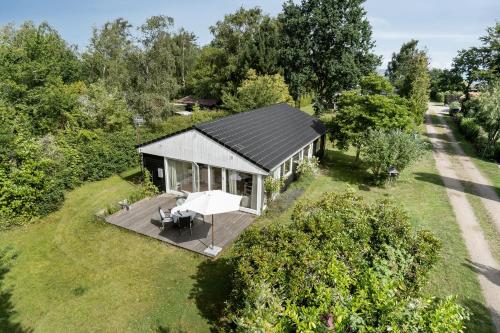 an overhead view of a small house with a deck at Presence And Coziness Close To The Beach in Gørlev