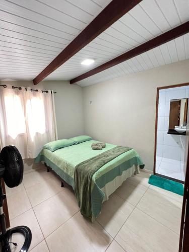 a bedroom with a bed in a room at Chalé Recanto da Paz in Mulungu