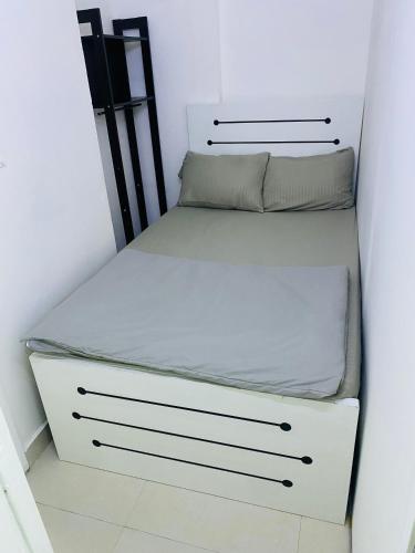 a small bedroom with a bed in a room at cozy pavilion in Dubai