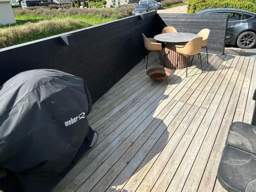 a patio with a table and chairs and a tent at New Holiday Home 30 Meters From The Beach in Kolding