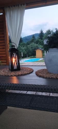a lantern is sitting on a patio with a vase at Turizam Koturovic in Ivanjica