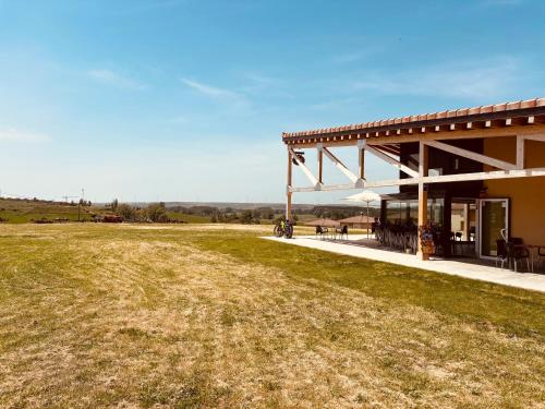 un pavillon avec une table et des chaises dans un champ dans l'établissement Villa Alicia-Casa Rural, 