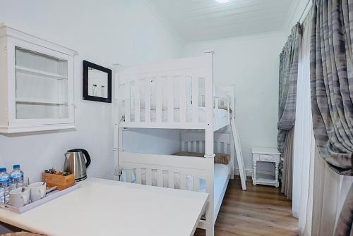 a bedroom with two bunk beds in a room at Albatross Guest House Bantry Bay in Cape Town
