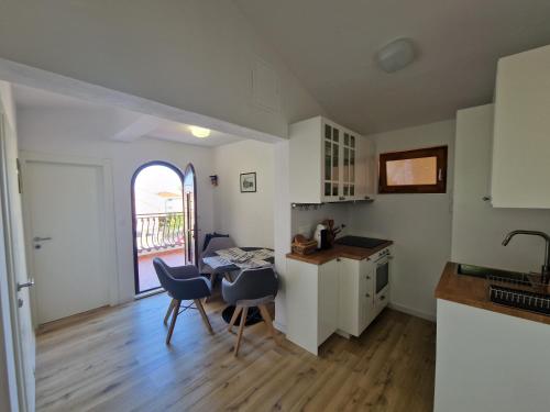 a kitchen and dining room with a table and chairs at Apartments Dara in Rogoznica