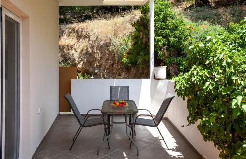 a table and two chairs on a patio at AZOGIRE Resort in Azoyirés