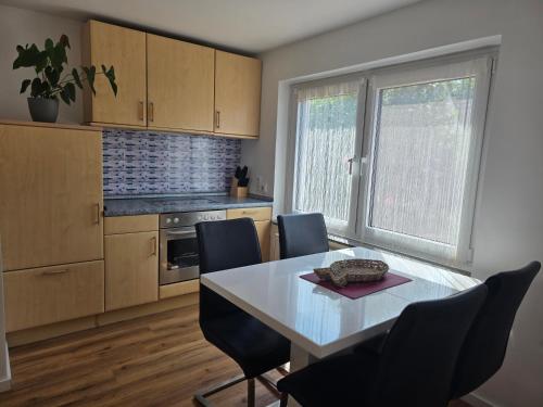 a kitchen with a table and chairs in a room at Kezara Living in Konz