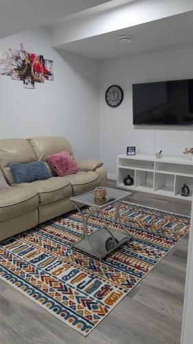a living room with a couch and a rug at Cozy Escape Guest Suite in Edmonton