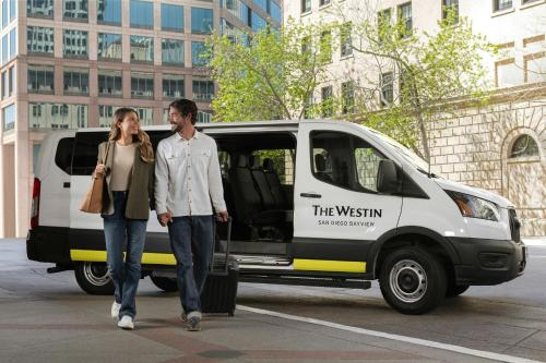 a man and woman walking in front of a van at The Westin San Diego Bayview in San Diego